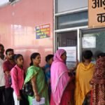 Group of Assam NHM health workers holding protest signs against job insecurity