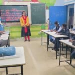 a rural school building in Odisha with students and teachers