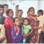 a rural well in a village with people in the background