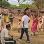a dark rural area with people gathered