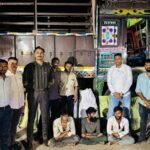 Police officers holding seized ganja bags in Rajkot